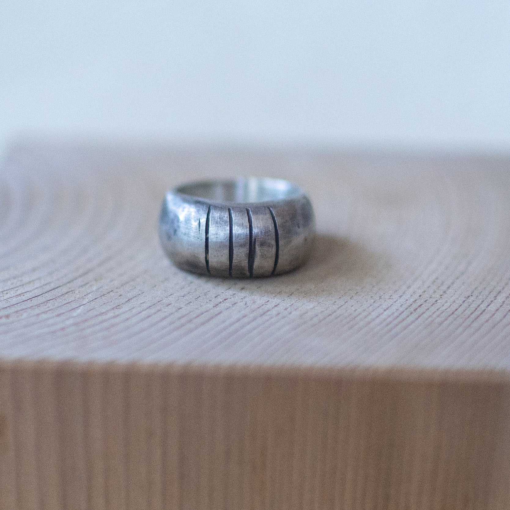 Handcrafted sterling silver ring with bold segmented grooves, The Armadillo size 7 – artisan unisex jewelry with a rugged, textured design."