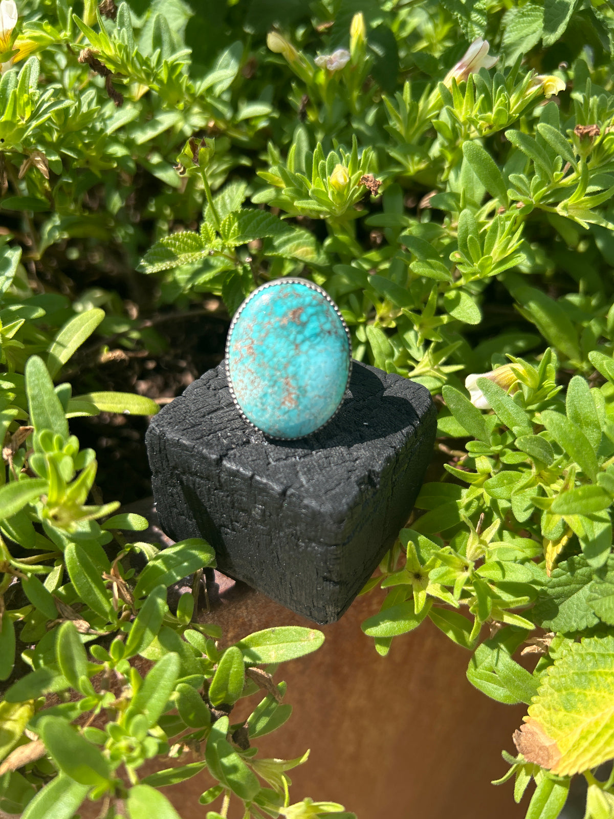 Handmade sterling silver ring featuring an oval Royston Turquoise cabochon with bright blue color and natural brown matrix.