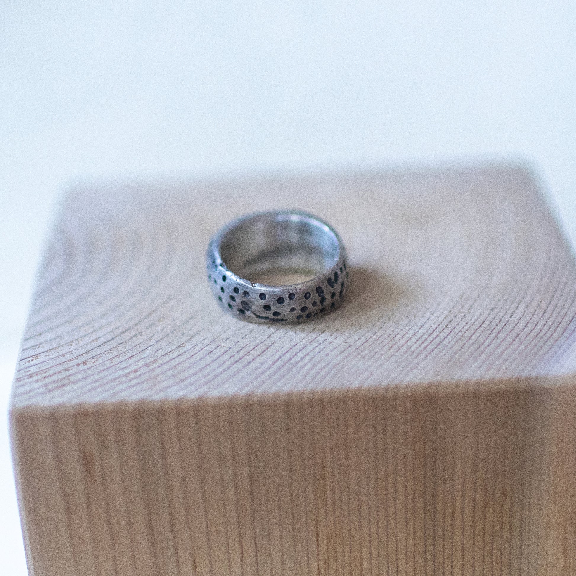 Handcrafted sterling silver ring with bold segmented grooves, The Armadillo size 7 – artisan unisex jewelry with a rugged, textured design."