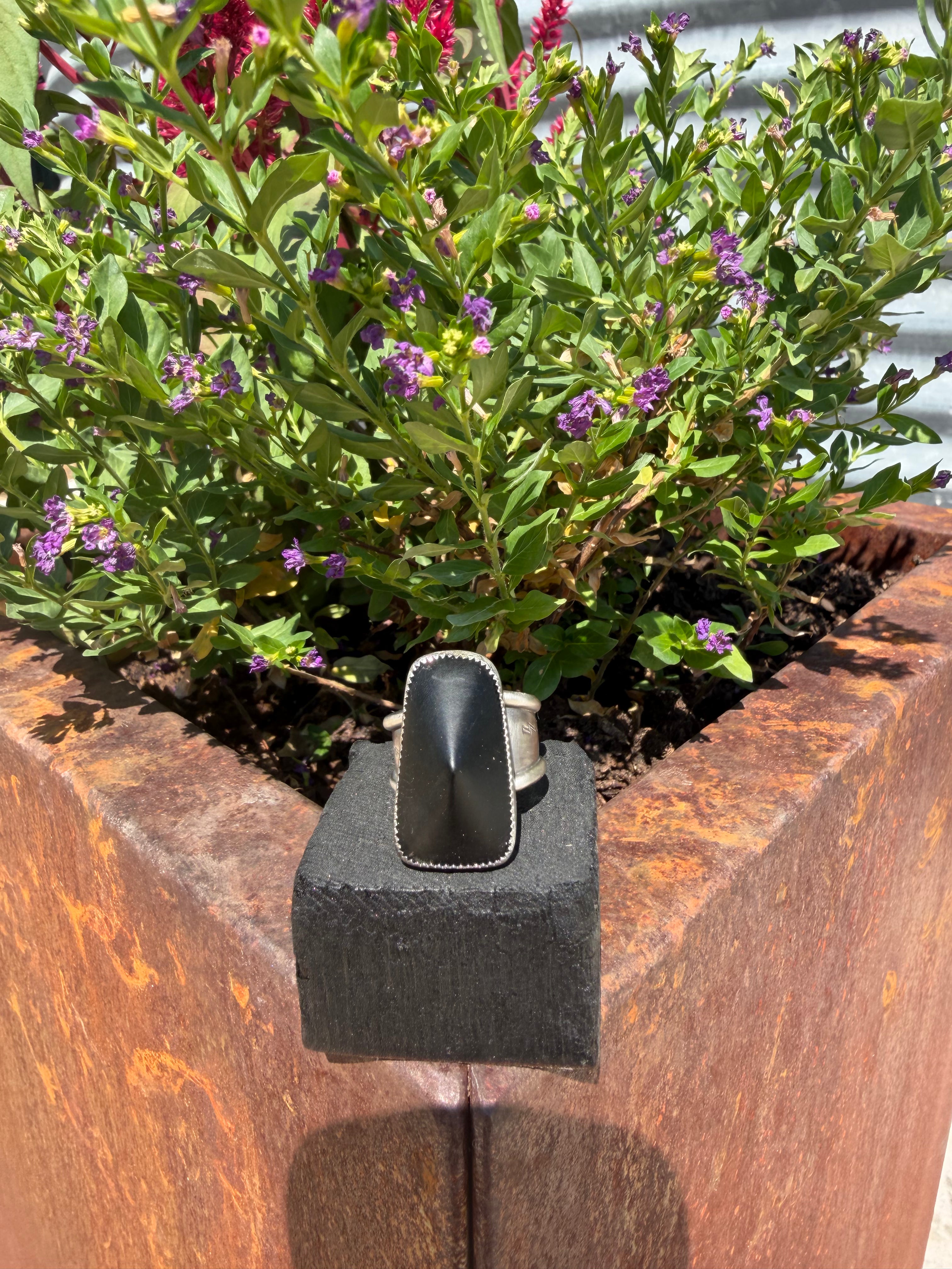 Master size 11 ring with coned black onyx stone wrapped in sterling silver on layered stamped band