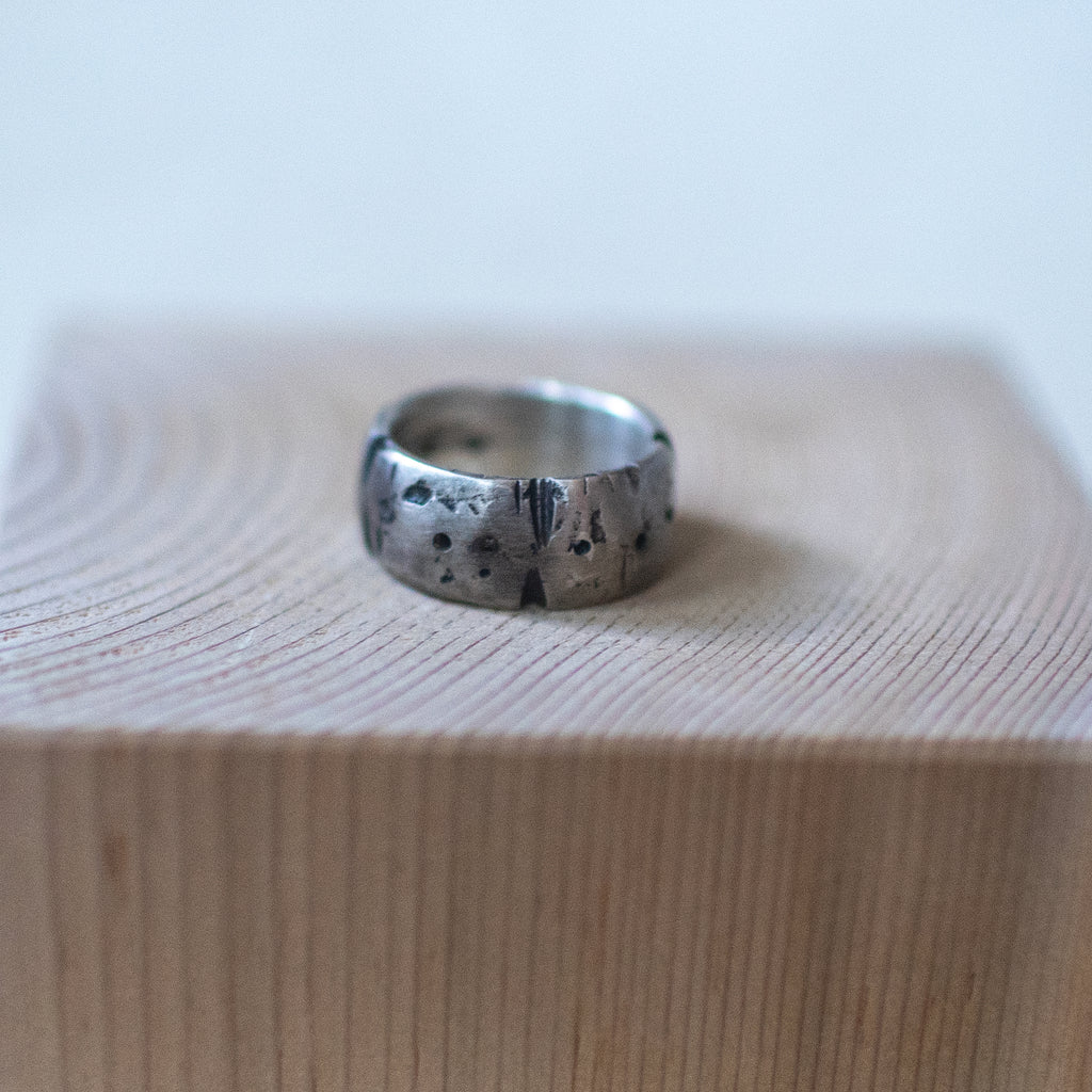 Caldera ring – handcrafted sterling silver band size 9.5 with cratered volcanic-inspired texture and oxidized finish, unisex artisan jewelry.
