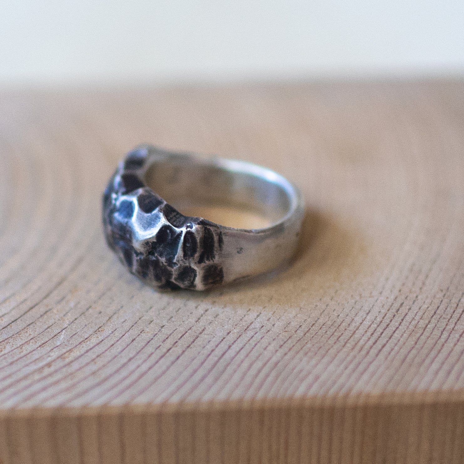 The Rock – handmade sterling silver ring with raw hammered texture and dark oxidized details, artisan unisex jewelry with rugged, earthy style